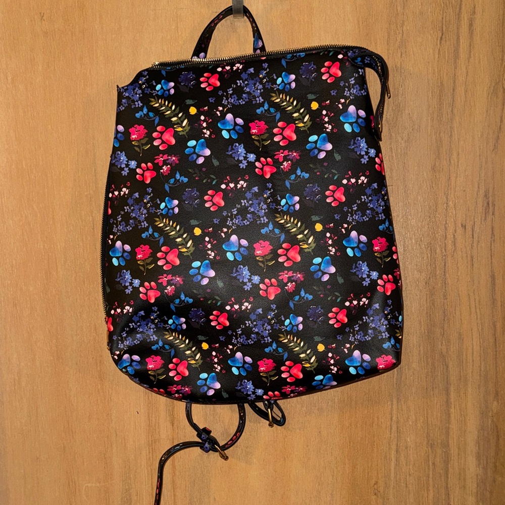 The Animal Rescue Site Paw Prints Galore Floral Backpack
Pet Lover's On-the-Go